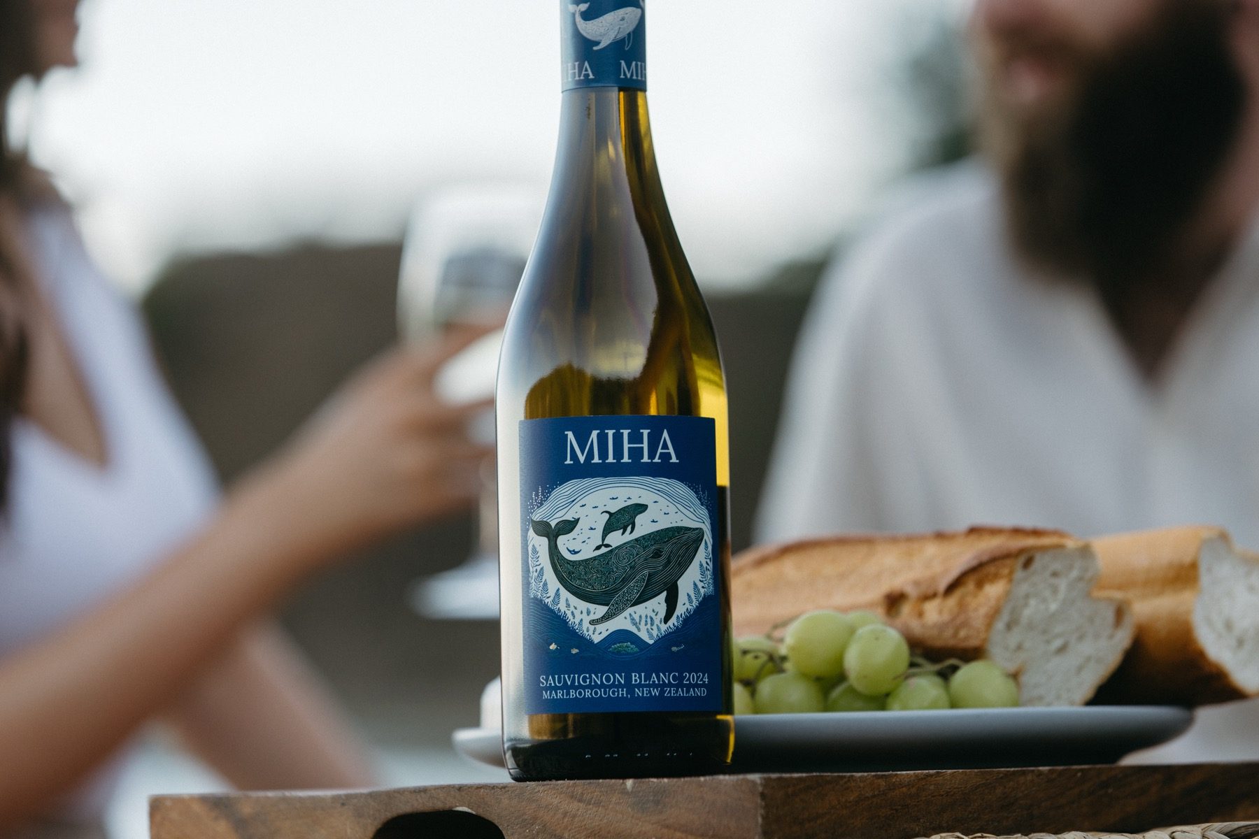 MIHA on an outdoor table with grapes and bread